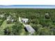 Aerial view of the property featuring a secluded house and garage surrounded by lush greenery at 6510 24Th E Ave, Bradenton, FL 34208