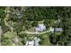 An overhead view shows the home and detached garage nestled among verdant trees at 6510 24Th E Ave, Bradenton, FL 34208