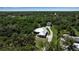 Stunning aerial view of a home nestled in lush greenery, featuring a metal roof and a detached garage at 6510 24Th E Ave, Bradenton, FL 34208