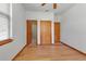 Bedroom with wood floors and closet with doors leading to a shower room at 6510 24Th E Ave, Bradenton, FL 34208