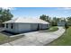 An inviting single-story home features a metal roof and an attached two-car garage at 6510 24Th E Ave, Bradenton, FL 34208