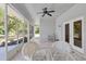 Enclosed patio with screened windows, tile flooring, a ceiling fan and outdoor seating at 6510 24Th E Ave, Bradenton, FL 34208