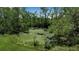 A beautiful pond covered in lily pads surrounded by lush green trees at 6510 24Th E Ave, Bradenton, FL 34208