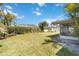 Expansive backyard showcasing a well-maintained lawn, lush hedges and a charming sunroom at 6812 19Th W Ave, Bradenton, FL 34209