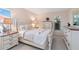 The light and airy bedroom has a white furniture set and large windows at 6812 19Th W Ave, Bradenton, FL 34209