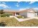 Charming single-story home with a well-manicured lawn, featuring a two-car garage and inviting pink front door at 6812 19Th W Ave, Bradenton, FL 34209