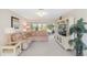 Comfortable living room with plush seating, neutral carpeting, and a large window offering ample natural light and a serene view at 6812 19Th W Ave, Bradenton, FL 34209