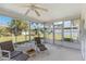 Enclosed sunroom features lounge seating and bright views of the landscaped exterior at 6812 19Th W Ave, Bradenton, FL 34209