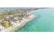 Breathtaking aerial view showcasing beachfront homes along a pristine coastline with mature trees and surrounding waterways at 7324 Point Of Rocks Rd, Sarasota, FL 34242