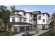 Modern luxury home with multi-level balconies and an attached garage at 7324 Point Of Rocks Rd, Sarasota, FL 34242