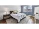 Comfortable main bedroom featuring two windows, light-colored wood look floors, area rug and ensuite bathroom at 7583 Aguila Dr, Sarasota, FL 34240