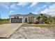 Home exterior with a gray garage door, horse decoration and covered front porch at 7901 Hawkins Rd, Sarasota, FL 34241