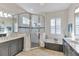 Bathroom with a stand-alone shower, soaking tub, and dual sinks at 8224 Larkspur Cir, Sarasota, FL 34241