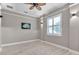 Bright bedroom featuring a ceiling fan, shutters, and neutral paint at 8224 Larkspur Cir, Sarasota, FL 34241