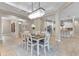 Bright dining room boasts a modern chandelier and seating for six, creating an inviting space at 8224 Larkspur Cir, Sarasota, FL 34241