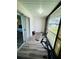 Enclosed balcony featuring wood-look floors, a door, large windows, and exercise equipment at 105 47Th Avenue W Dr # 377, Bradenton, FL 34207