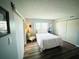 Well-lit bedroom featuring a comfortable bed, chair, sliding glass doors, and closet space at 105 47Th Avenue W Dr # 377, Bradenton, FL 34207