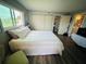 Cozy bedroom featuring closet space, a window with greenery, and easy access to a bathroom at 105 47Th Avenue W Dr # 377, Bradenton, FL 34207