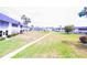 Expansive community grounds with lush green grass, mature palm trees, and well-maintained landscaping at 105 47Th Avenue W Dr # 377, Bradenton, FL 34207