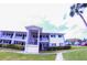 Two story condo building showing balconies, lawn, shrubbery, sidewalk and a palm tree at 105 47Th Avenue W Dr # 377, Bradenton, FL 34207