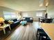 Bright, open living area with plank flooring, comfortable sofas, and a charming dining table at 105 47Th Avenue W Dr # 377, Bradenton, FL 34207