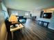Comfortable living room featuring wood-look flooring and ample natural light from large windows at 105 47Th Avenue W Dr # 377, Bradenton, FL 34207