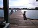 View of a fishing pier in a lake or ocean with people fishing from the sides at 105 47Th Avenue W Dr # 377, Bradenton, FL 34207