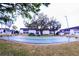 Well-maintained shuffleboard court nestled among mature trees and landscaping with park benches around it at 105 47Th Avenue W Dr # 377, Bradenton, FL 34207