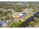 An aerial view of a quiet neighborhood on the water with mature trees at 108 Mccabe St, Port Charlotte, FL 33953