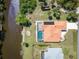 Stunning aerial view of home with a screened pool, dock and waterfront access at 108 Mccabe St, Port Charlotte, FL 33953