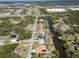 An aerial view of a canal neighborhood with shops and homes nearby at 108 Mccabe St, Port Charlotte, FL 33953