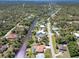An aerial view of this canal front neighborhood with mature trees and lush landscaping at 108 Mccabe St, Port Charlotte, FL 33953