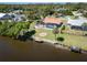 The backyard features a screened pool, firepit and waterfront access with dock at 108 Mccabe St, Port Charlotte, FL 33953