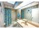 Bathroom with a combination tub and shower, fish-themed decor, and a vanity sink at 108 Mccabe St, Port Charlotte, FL 33953