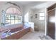 Garden tub in a bathroom featuring tiled floor, natural light, and a separate shower at 108 Mccabe St, Port Charlotte, FL 33953