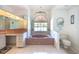 Large main bathroom features a soaking tub, vanity area, and tiled floors at 108 Mccabe St, Port Charlotte, FL 33953