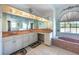 This bathroom boasts double sinks, vanity area, large mirror, and a garden soaking tub at 108 Mccabe St, Port Charlotte, FL 33953