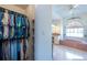 View into the walk-in closet, and glimpse of the main bath with tub at 108 Mccabe St, Port Charlotte, FL 33953