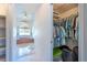 View into the walk-in closet, and glimpse of the main bath with tub at 108 Mccabe St, Port Charlotte, FL 33953