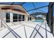 The exterior of this home features a screened pool, white pavers and neutral paint at 108 Mccabe St, Port Charlotte, FL 33953