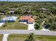 Beautiful home with a well-manicured lawn, circular driveway, and waterfront access at 108 Mccabe St, Port Charlotte, FL 33953