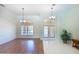 Bright foyer with tiled floors, chandelier, and a plant that welcomes you into this beautiful home at 108 Mccabe St, Port Charlotte, FL 33953