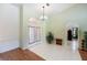 Inviting foyer with white tile flooring, a decorative chandelier, and a plant that adds a touch of nature at 108 Mccabe St, Port Charlotte, FL 33953