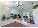 Cozy living room featuring vaulted ceilings, a ceiling fan, and natural light to create a relaxing atmosphere at 108 Mccabe St, Port Charlotte, FL 33953