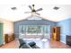 Living room with vaulted ceiling, large bay window, and wood-look floors at 108 Mccabe St, Port Charlotte, FL 33953