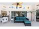Enclosed patio featuring a ceiling fan, a wicker chair, and a blue sofa with a coffee table at 108 Mccabe St, Port Charlotte, FL 33953