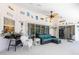 Enclosed patio featuring a ceiling fan, a wicker chair, and a blue sofa with a coffee table at 108 Mccabe St, Port Charlotte, FL 33953