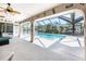 Enclosed pool area with screened walls and ceiling fan to cool off from the summer heat at 108 Mccabe St, Port Charlotte, FL 33953