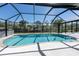A beautiful private screened pool with sun-drenched white pavers, perfect for swimming and outdoor enjoyment at 108 Mccabe St, Port Charlotte, FL 33953