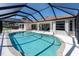 A beautiful private screened pool with sun-drenched white pavers, perfect for swimming and outdoor enjoyment at 108 Mccabe St, Port Charlotte, FL 33953